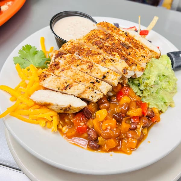 Grilled chicken breast with shredded cheese, salsa, guacamole, and a side of creamy dressing.